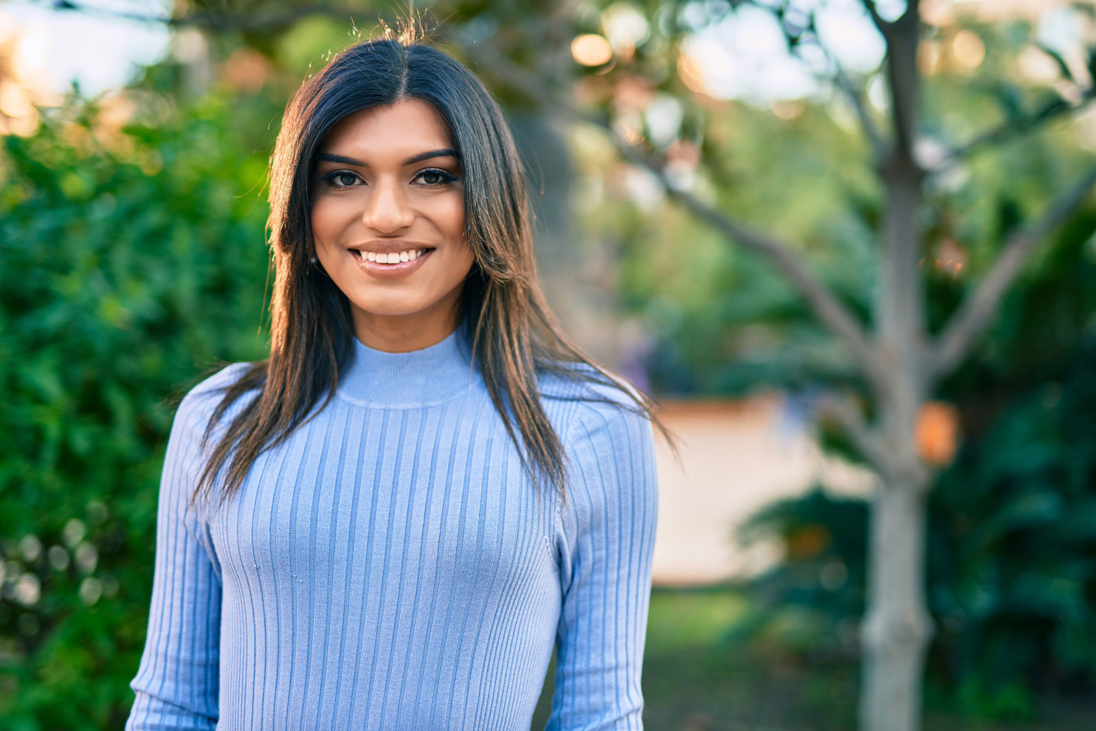 Beautiful hispanic woman smiling confient at the park